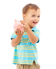 Image showing Child, boy and piggy bank for money, saving and smiling in studio by white background. Happy male person, boy and moneybox for future, investing and cash growth in container, coin and security