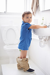 Image showing Child, boy and washing hands in portrait, hygiene and prevention of germs or bacteria in bathroom. Male person, kid and crazy humor or funny joke while potty training, cleaning and sanitary care