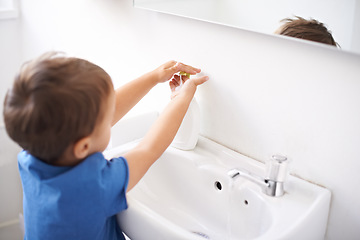 Image showing Child, boy and liquid soap for washing hands in bathroom, hygiene and prevention of germs or bacteria at home. Male person, kid and learning at basin or cleaning and sanitary, water and disinfection