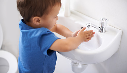 Image showing Child, boy and water for washing hands in bathroom, hygiene and prevention of germs or bacteria at home. Male person, kid and learning at basin or cleaning and sanitary, liquid soap and disinfection