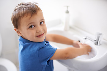 Image showing Child, boy and washing hands in portrait, water and prevention of germs or bacteria in bathroom. Male person, kid and learning at basin or cleaning and sanitary, liquid and disinfection at home