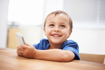 Image showing Toddler, boy and texting at home, happiness and communication with technology. Table, chatting and conversation for learning, cellphone and excited for child development, mobile phone and digital