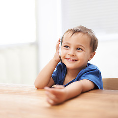 Image showing Toddler, boy and phonecall at home, happiness and communication with technology. Table, calling and conversation for learning, cellphone and excited for child development, mobile and digital