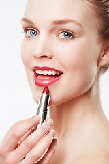 Image showing Portrait, application and model in studio with red lipstick, beauty cosmetics and mock up by white background. Woman, foundation and aesthetic for glow face with color product and soft lips results