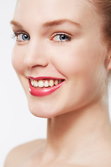 Image showing Portrait, red lipstick and model in studio with makeup, cosmetics and happy by white background. Woman, glow face and confident with beauty aesthetic, blue eyes and blonde hair with skincare results