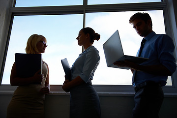 Image showing Silhouette, dark office and professional people conversation on development project, planning or brainstorming plan. Communication, research collaboration and workforce talking about sales strategy