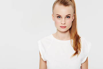 Image showing Serious, teenager and portrait with fashion in studio and white background with confidence and pride. Beauty, face and girl with a ponytail in casual trendy style with makeup in mock up space