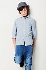 Image showing Child, boy and portrait for style in studio, cool clothing and confident by white background. Happy male person, kid and hat by backdrop or pride for fashion, face and trendy outfit in childhood