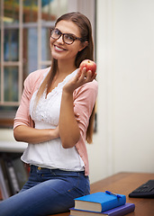 Image showing School teacher, apple and smile in classroom portrait, education and knowledge or learning. Female person, face and healthy diet or fruit for nutrition, brain food and happy or pride for career