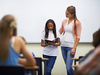 Image showing Presentation, class and teacher with book to read in front for classmates, ready and learning. Elementary school, girl and prepared oral with workbook, childhood development and academic education