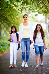 Image showing Mother, daughter and holding hands in road for school with portrait, happiness and backpack or books. Family, woman and children in street with support for education, learning and parenting with love