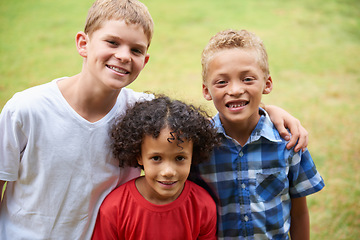 Image showing Boys, friends and portrait or happy on field in summer with confidence, pride or diversity in nature. Children, face or smile on grass with embrace for friendship, care and support on playground