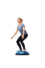 Image showing Workout, half ball and woman balance for wellness challenge, studio exercise or practice pilates on gym equipment. Activity, stability training and athlete in fitness routine on white background