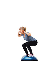 Image showing Woman, workout and squat with balance ball for fitness, exercise or training on a white studio background. Active female person squatting for strength, muscle or strong glutes on mockup space