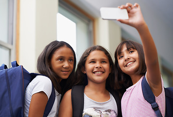 Image showing Friends, children and smile for selfie in elementary school lobby for fun educational memory together. Group of students, young girls and kids taking picture for social media, photography or learning