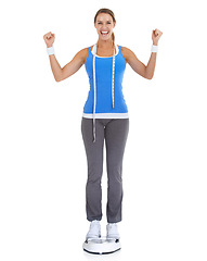 Image showing Woman, celebration and scale or measure tape in studio for fitness, weight loss success or health results. Model portrait for diet goals, exercise balance or workout achievement on a white background