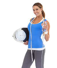 Image showing Woman, water bottle and scale in studio for health, diet and exercise, fitness or wellness results on a white background. Portrait of sports model with measure tape and liquid for training progress