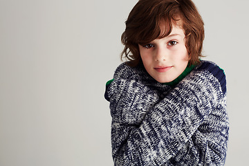 Image showing Portrait, style and boy child in a studio with winter, casual and stylish outfit with positive attitude. Youth, clothes and young kid model with cool fashion posing and isolated by gray background.