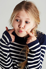 Image showing Fashion, goofy and girl kid in a studio with casual, cool and stylish jersey outfit. Silly, comic and funny young child model with trendy youth style and positive attitude by gray background.