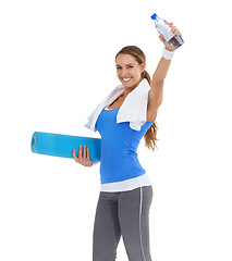 Image showing Yoga mat, water bottle and portrait of woman in studio for exercise, training or workout. Happy, fitness and young female person with hydration drink for sports isolated by white background.