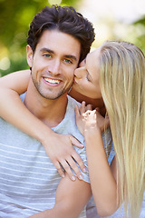 Image showing Couple, hug and woman kiss man in park with smile, love and commitment in healthy relationship. People on date outdoor, portrait and care with trust, partner and bonding together for marriage