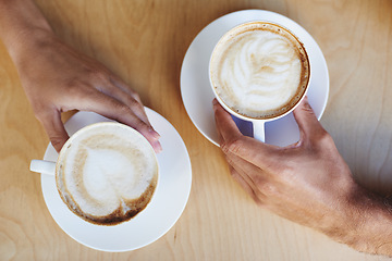 Image showing Top view, hands or couple in cafe with a coffee to relax with care, morning espresso or support. Closeup, date or people with tea, cappuccino or romance with love, peace or cup of tea in restaurant