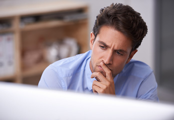 Image showing Business man in office, thinking and reading on computer, lawyer busy with case research, review and analysis. Professional, workflow and productivity with attorney in workplace, expert and solution