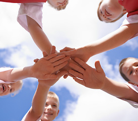 Image showing Hands, collaboration and group of children on soccer team, below and huddle or support in circle. People, solidarity and stack or partnership and trust in community, together and sky background