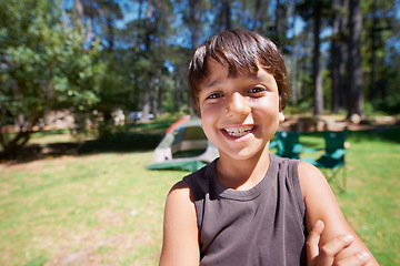 Image showing Child, portrait and fun on camping adventure in outdoors, boy and relaxing on vacation or holiday. Happy male person, kid and face or confident in park, childhood and summer or freedom on lawn