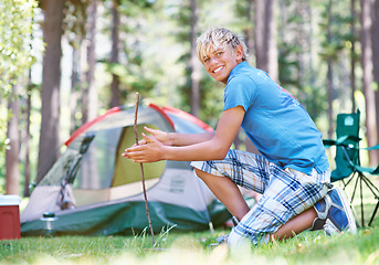 Image showing Start, campfire or portrait of boy in woods for summer camp, survival education or learning. Kid, spark or happy male child on adventure with sticks or smile in nature on holiday vacation in forest