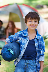 Image showing Sleeping bag, camping or portrait of happy child in woods on adventure or holiday vacation in nature. Relax, start or boy with smile in park, garden or forest ready for fun hiking, travel or wellness