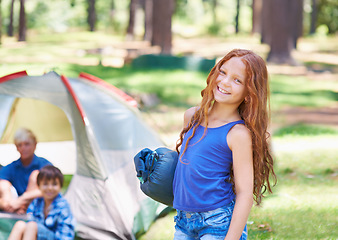 Image showing Sleeping bag, camping or portrait of happy child in forest on adventure or holiday vacation in nature. Relax, start or girl with smile in park, garden or park ready for experience, travel or wellness