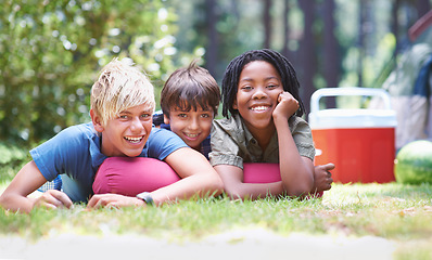 Image showing Camping, children and relaxing in portrait on vacation, bonding and happy for outdoor adventure. Kids, face and smiling together on holiday, friendship and childhood in nature, resting and grass