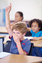 Image showing Young boy, classroom and hand up for bad smell, odor or scent sitting by desk at school. Little male person, student or youth with question to leave class from disgust, fart or breathe in bacteria