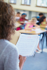 Image showing Classroom, test papers and school of students or learners in exam, files or results with folder. Closeup of teacher, academic and education for grading person for assignments, scholar and class grade