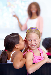 Image showing Little girls, whisper and classroom in ear for secret, gossip or communication in lesson at school. Children, students or friends listening to rumor, information or class together with teacher