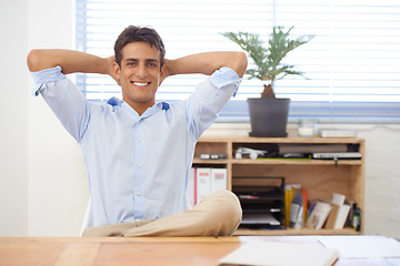 Image showing Portrait, relax or happy man in office on break for mental health, pride or wellness at his desk. Calm, freedom or male employee with smile or hand behind his head in a business stretching or resting