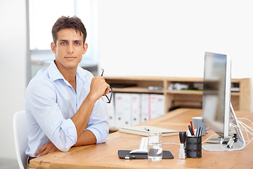 Image showing Office, portrait or employee with computer at desk with technology for project or solution. IT support, business or serious man programming with glasses or research online at workplace or workspace