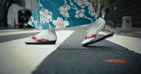 Image showing Japanese woman, feet and walking in kimono in city, journey and wellness for heritage by outdoor. Person, steps and traditional clothes in tokyo for holiday and pedestrian crossing in japan fashion