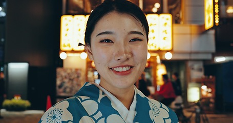 Image showing Japanese woman, kimono or happy in portrait at night, city or religion on heritage celebration. Young person, face or traditional clothes in tokyo in beauty, wellness or pride in indigenous fashion