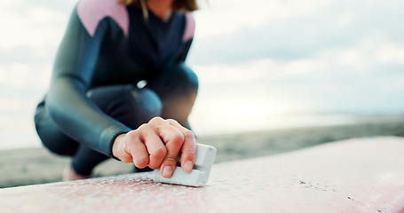 Image showing Surfing, ocean and woman with wax for surfboard for water sports, fitness and freedom on beach. Nature, travel and happy Japanese person on sand for wellness on holiday, vacation and adventure by sea