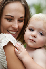 Image showing Baby, closeup and mom outdoor with love for boy in garden or backyard. Infant, kid and mother bonding together in hug and embrace with care, support and relax in park, nature or forest environment