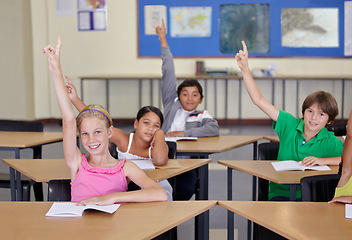 Image showing Students, classroom portrait and raise hands for questions, education or learning for geography quiz in school. Happy youth, group or smart kids for teaching support, class ideas and answer or advice