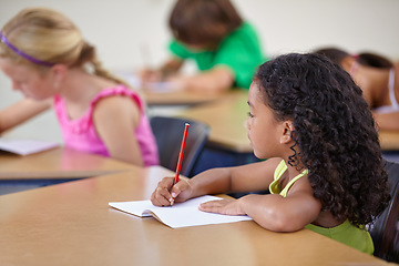 Image showing School, girl and writing in book in classroom for education, studying lesson or learning assessment at desk. Children, student or kids drawing in notebook for academic development, test or knowledge