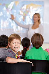 Image showing Child, portrait and classroom with teacher for education, teaching and geography lesson or support in primary school. Face of a boy, kid or students for learning, map information and global knowledge