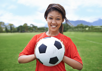 Image showing Woman, football field and portrait with ball, happy and soccer player for match, competition and game. Fitness, practice and ready for training, outdoor and exercise for athlete, fun and sport