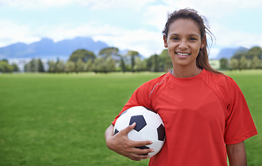 Image showing Girl, football field and portrait with ball, happy and soccer player for match, competition and game. Fitness, practice and ready for training, outdoor and exercise for athlete, fun and sport