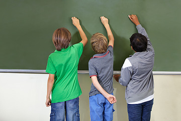 Image showing Children, chalkboard and school drawing with education, writing and answer for learning. Back, knowledge and youth development in a study lesson with students in classroom with chalk and solution