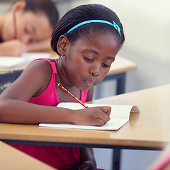 Image showing Black girl, school or writing in classroom with notebook, studying lesson or learning academic assessment at desk. Student, child or kid drawing on paper in educational development, test or knowledge