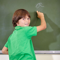 Image showing Portrait, chalkboard and kid at school with writing for education and answer while learning. Back, knowledge and youth development in a lesson with student in classroom with chalk and solution